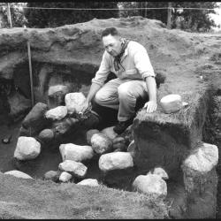 black and white photo man sitting in ground 