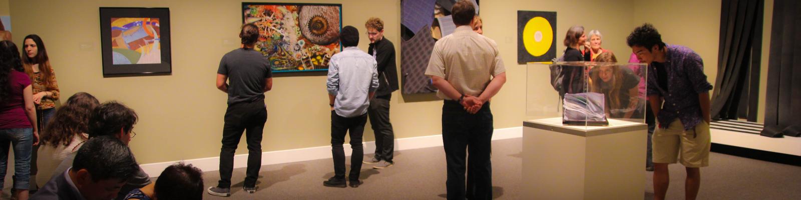 people looking at artwork